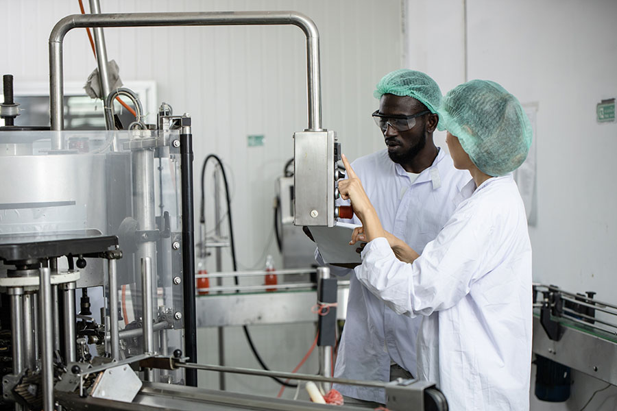 two workers in a food manufacturing plant